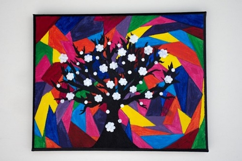 A painting of a black tree with white blossoms on a background of coloured shapes