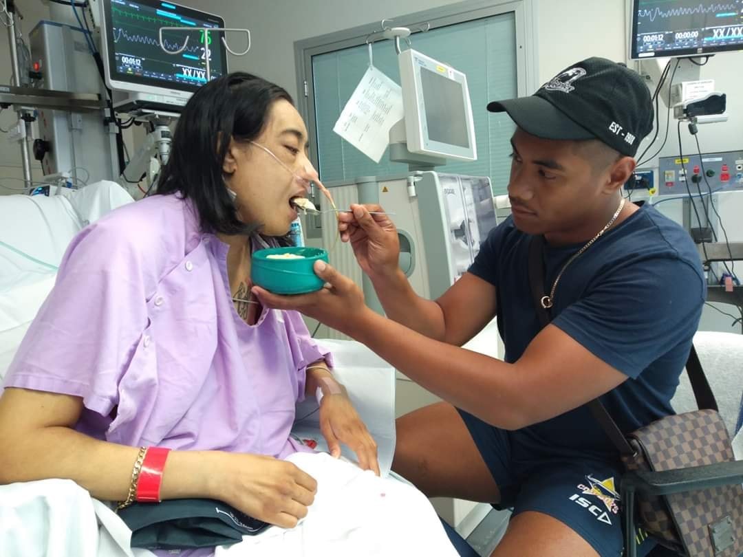 "Rosa being fed by her son EJ while in hospital"