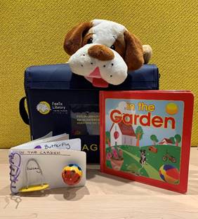 Feelix library kit of "In The Garden" with plush dog and tactile story book