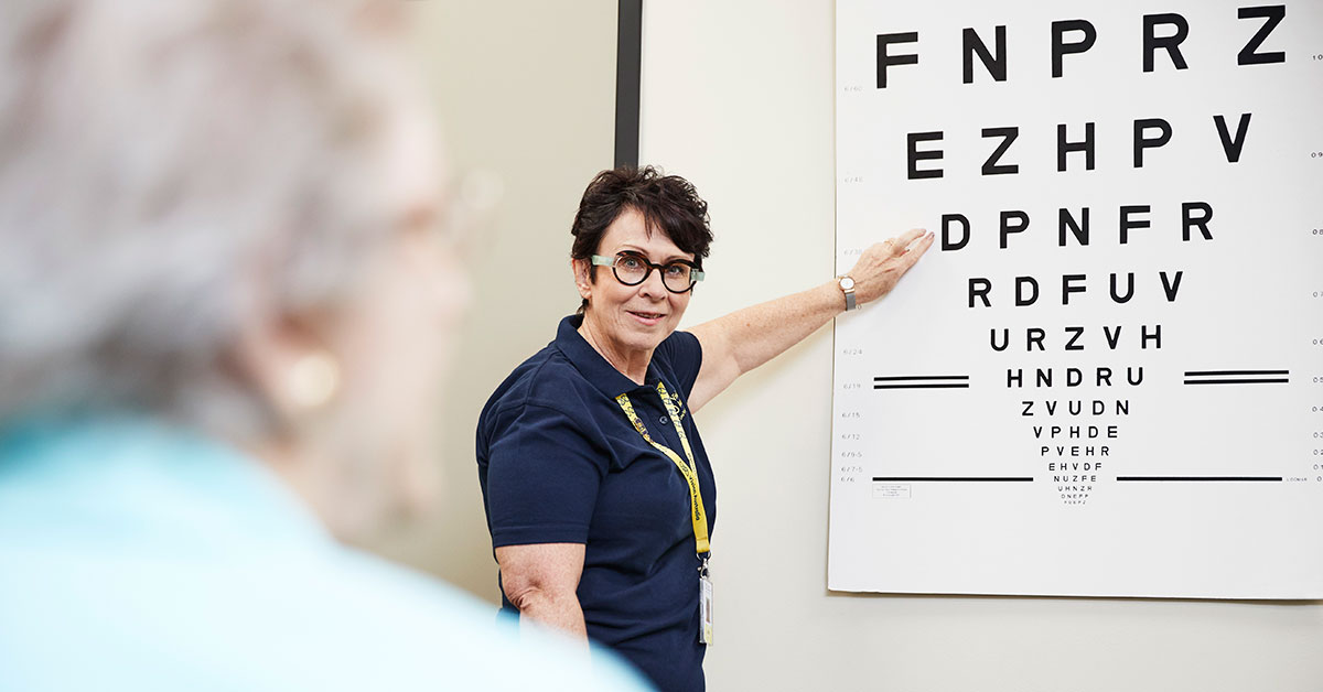 Vision Australia clinician points to an eye chart